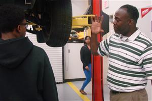 Explaining the customer complaint to students, as they decide which diagnostic path will guide them to the cause 